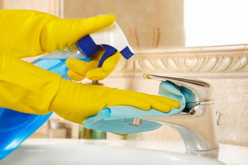 Technician cleaning oven components and racks during a kitchen service