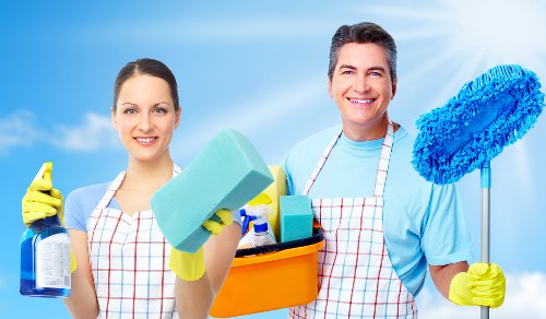 Protective gloves and cleaning supplies used during oven cleaning